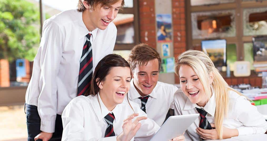GCSE Students gathered around a tablet device